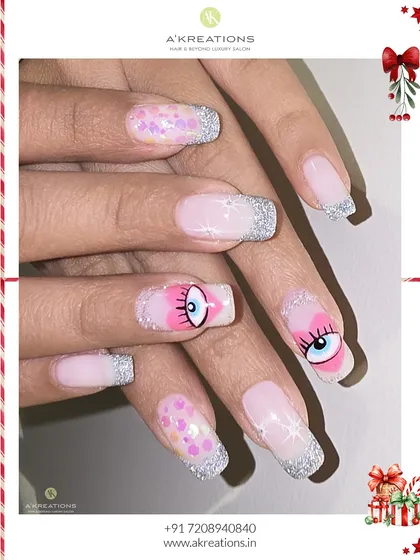 A playful and unique holiday design. This set features silver glitter tips, pink accents, and a quirky, hand-painted cartoon eye for a look that is both festive and fun.