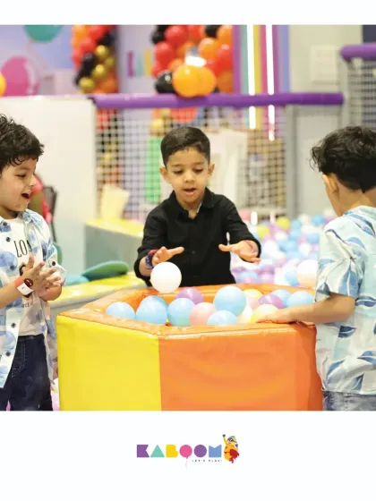 Teamwork makes the dream work! Friends gather around the ball pit station for some interactive and collaborative fun.