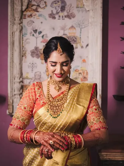 This is a quintessential South Indian muhurtham look. I created a flawless base with a bold red lip for Supritha, which stands out beautifully against her golden silk saree and traditional jewellery. The detailed bridal braid completes this timeless look.