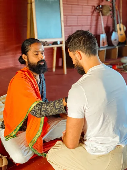 I sit with a student for a personal consultation. These one-on-one sessions are crucial for addressing individual questions and guiding each student on their unique path.
