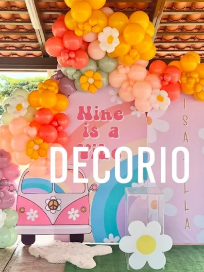 A groovy and colorful 9th birthday party with a retro daisy theme. This fun setup features a pink VW bus cutout, vibrant balloon arrangements, and daisy accents for a cheerful vibe.