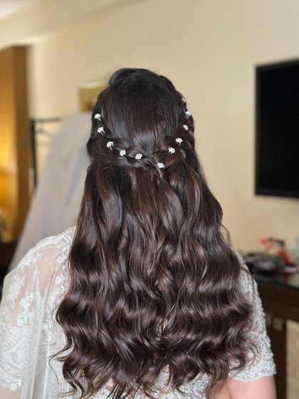 The hairstyle from a different angle, capturing the soft waves and the beautiful accessory detail.