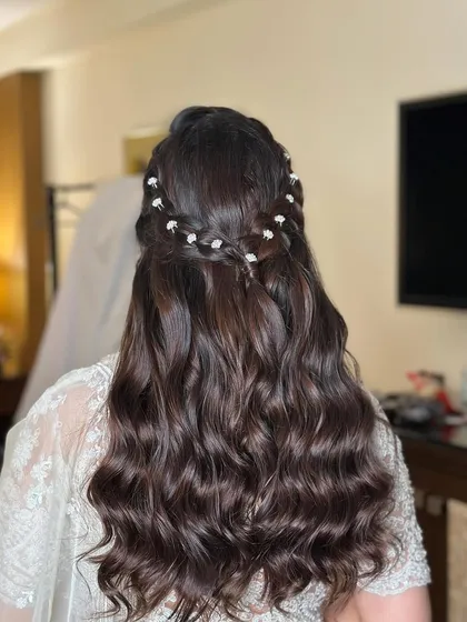 A full back view of the romantic and detailed half-updo.