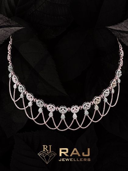 A delicate and feminine necklace with a scalloped design, featuring draped chains that create a waterfall effect. Each link is studded with CZ stones for a continuous, shimmering look.