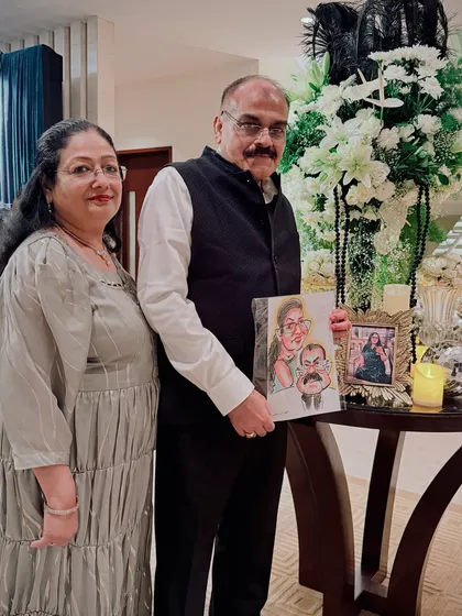 An elegant couple posing with their caricature at a private celebration. The artwork becomes a part of the decor and a cherished memory.