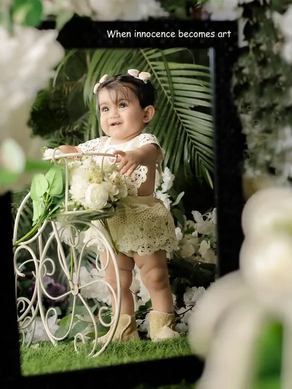Turning a simple moment into a piece of art. This creative setup with a mirror and floral elements shows how we can make your baby's portrait session truly unique.