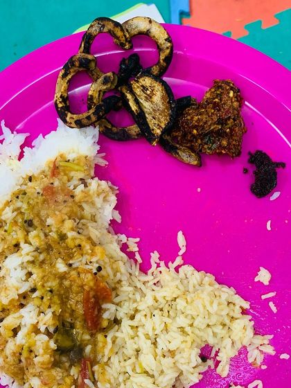 My lunch plate featuring rice, dal, and some delicious dried and roasted pork intestine.
