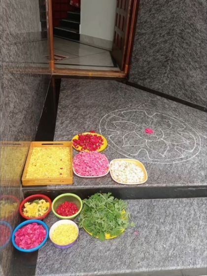 The setup for our Onam celebration. We provide children with colorful flower petals and other natural materials, allowing them to participate fully in the creation of the traditional Pookalam.