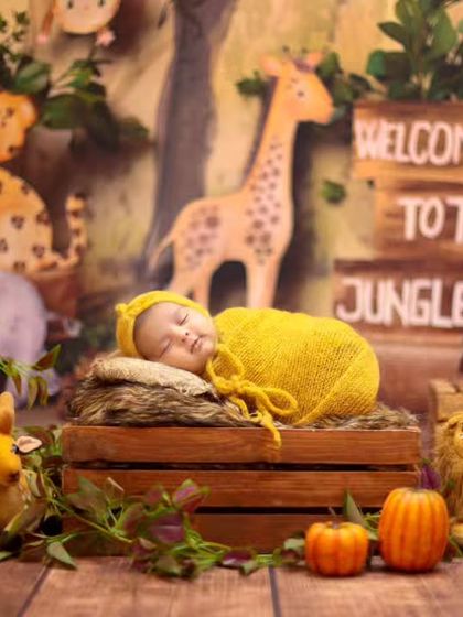 Welcome to the Jungle. This vibrant safari theme features a wooden crate bed, jungle backdrop, and a variety of cute animal props for a wild adventure.