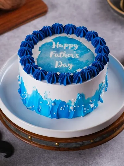 Celebrate your hero with our Father's Day cake. This one features a cool blue watercolor design and a "Happy Father's Day" message.