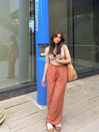 Another full-length shot, showing a different pose and the reflection in the glass.