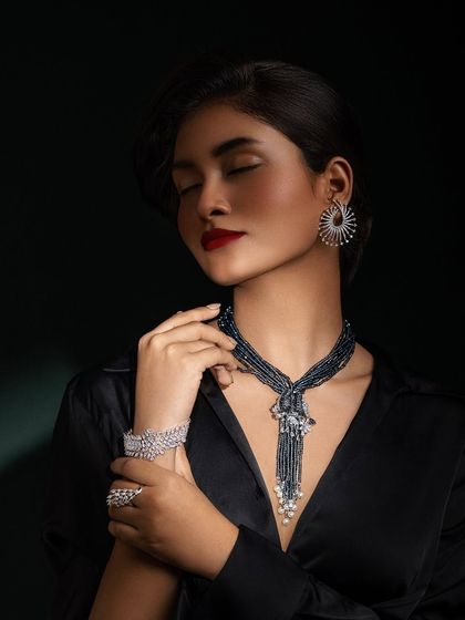 A sleek and sophisticated look for a diamond jewelry campaign. The black satin shirt and bold red lip create a dramatic contrast with the sparkling diamonds.