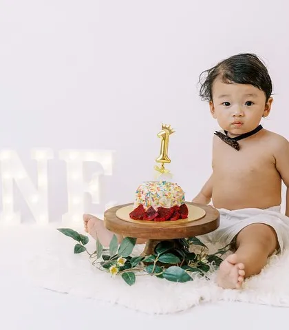 A moment of quiet contemplation with the birthday cake. Not every baby dives right in, and these thoughtful moments are just as sweet.