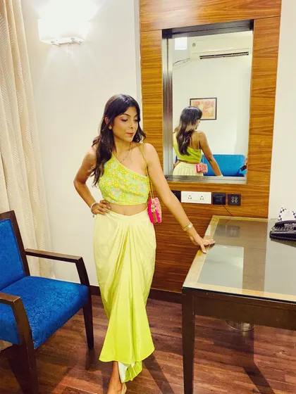 This modern, indo-western outfit is perfect for a cocktail or Sufi night. The one-shoulder top and draped skirt in this bright lime green are both trendy and comfortable. I love finding unique pieces like this for my clients.