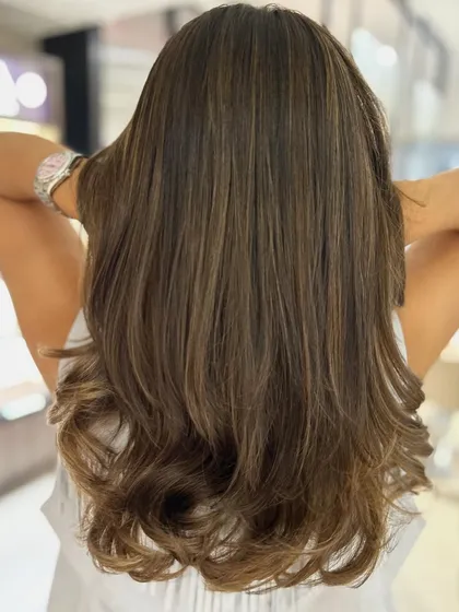 A birthday hair transformation featuring a beige and caramel balayage blend. The K18 treatment ensures the hair is healthy and ready to celebrate.