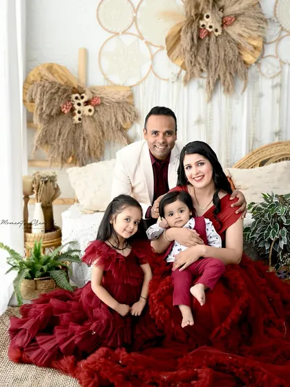 A returning family, now as a party of four! It's an honor to capture families as they grow. This portrait, with everyone in coordinated red outfits, is full of warmth and happiness.