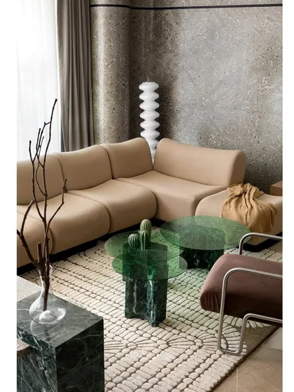 This shot captures the carefully curated material selections in the living room. The textures of the rug, the smoothness of the marble, and the softness of the bouclé fabric all blend seamlessly.