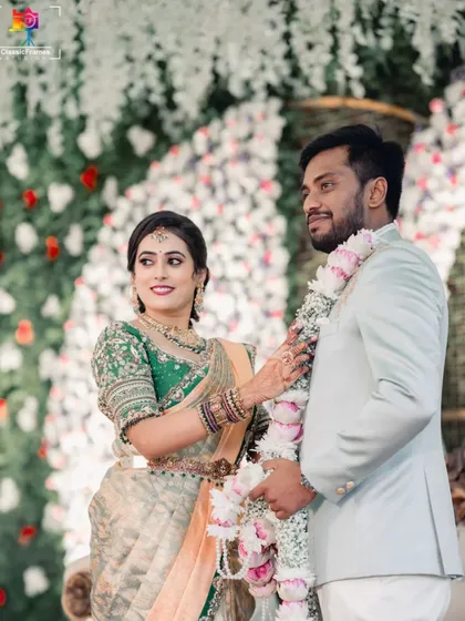The couple sharing a happy moment during their garland exchange ceremony. The bride's joyful expression is perfectly captured.