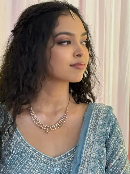 A profile shot of Sushmita, showing the soft contour and highlight. Her makeup is perfectly blended for a seamless, natural finish.