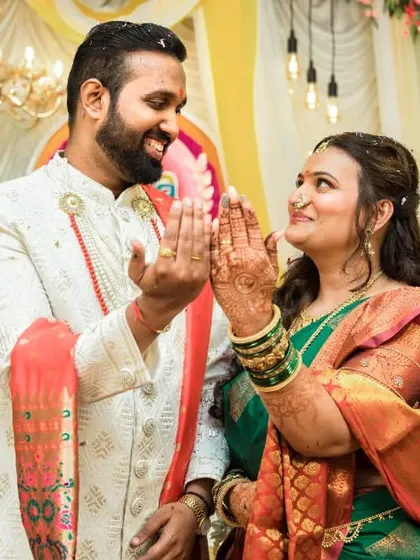 A playful and happy moment between the couple as they admire their new rings during their engagement function.
