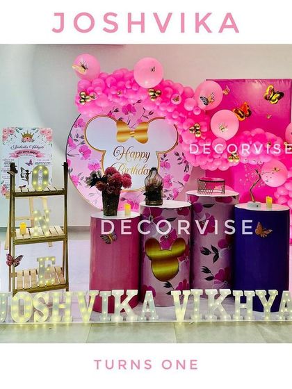 A duplicate image of the Minnie Mouse and butterfly theme for Joshvika's first birthday, showcasing the vibrant and personalized party stage.