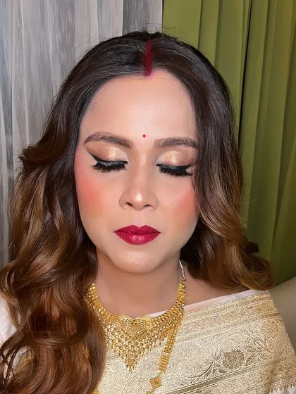 A close-up of the classic makeup look, featuring winged eyeliner and a bold red lip.