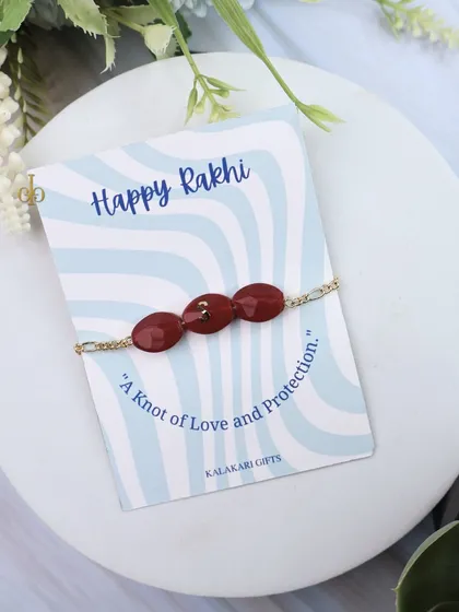 Our personalized Quartz Rakhi in a rich maroon color.