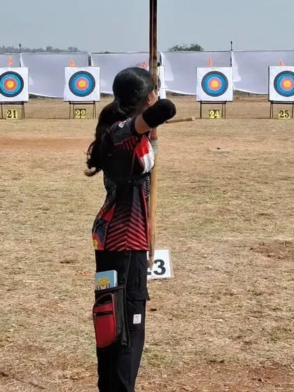 A junior archer takes her shot, aiming for the bullseye at the state championship.