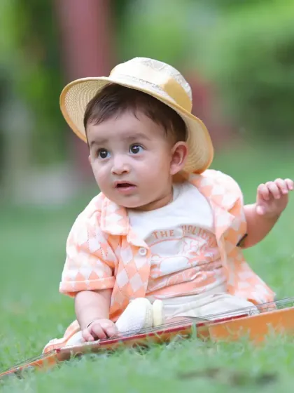 A curious expression captured during an outdoor session. The natural environment provides a beautiful and engaging backdrop for children's portraits.