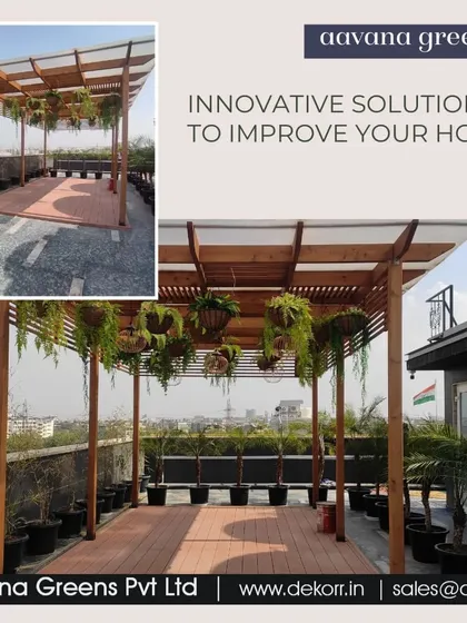 An innovative solution for a home terrace. This setup features a wooden pergola with hanging artificial plants, creating a shaded, green canopy for this outdoor seating area.