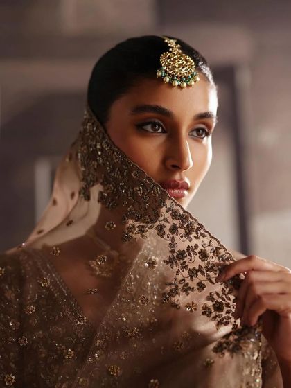 A portrait highlighting the delicate embroidery on a veil and a statement maang tikka. This shows my focus on the finer details that complete a bridal look.