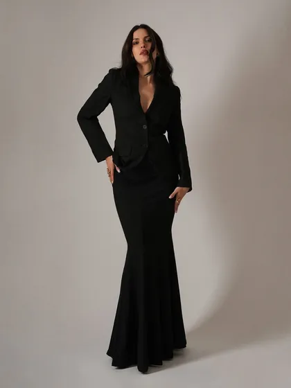 A full-length view of the dramatic silhouette we created for Natasa Stankovic. The combination of the fitted blazer and the flared mermaid skirt makes for a powerful and unforgettable evening wear look.