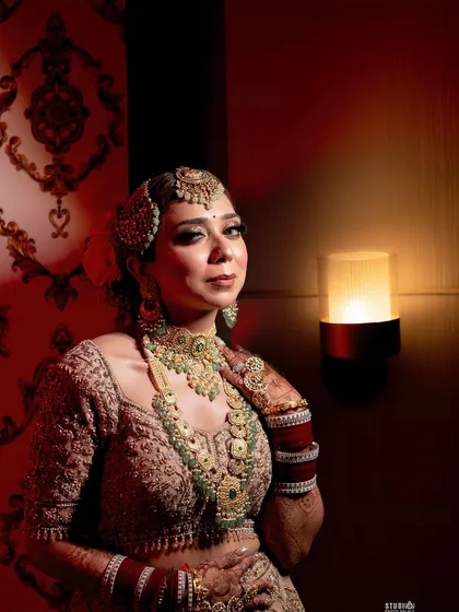 This was my own wedding day. As a makeup artist, creating my own bridal look was a dream. This photo captures the regal and traditional aesthetic I chose, with heavy jewelry and dramatic lighting.