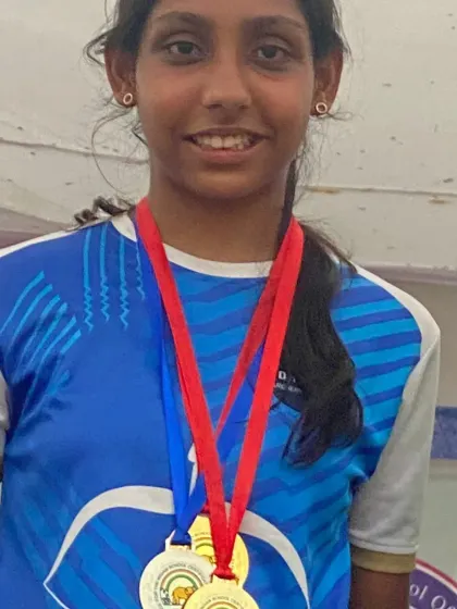 A close-up of a champion with her well-earned medals. This level of success is what our competitive archery program is designed to achieve.