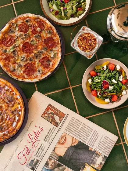 The full Fat Lulu's experience is about more than just one dish. It's a spread of gourmet pizzas, fresh salads, and a vibrant atmosphere that brings a cool, urban cafe vibe straight to your event.