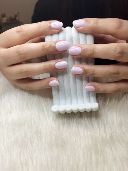 Clean, classic, unbothered. A beautiful milky lavender shade on short, rounded nails.