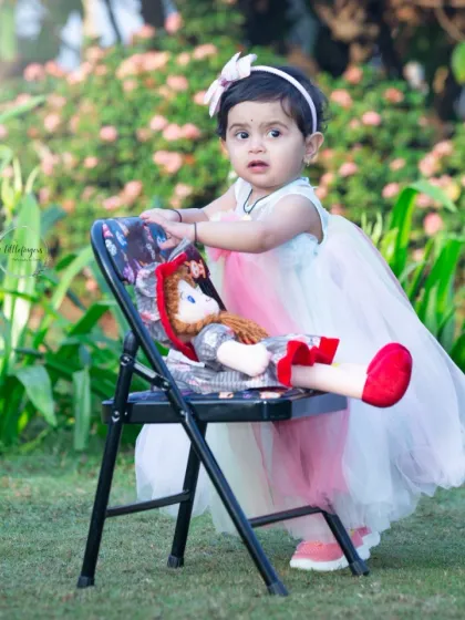 This little angel is standing tall with her favorite doll. I always encourage children to bring a favorite toy to their session to help them feel comfortable and to capture a snapshot of what they love at this age.