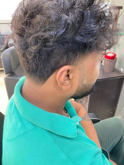 Another angle of the textured V-taper cut, showing the contrast between the messy top and the clean neckline.