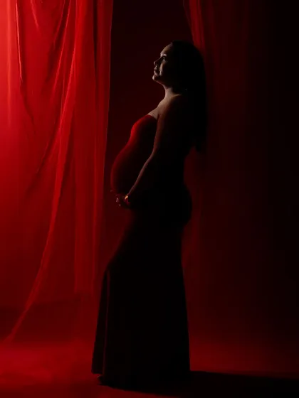 A silhouette from the same red-themed shoot, using shadows to create a dramatic and artistic profile.