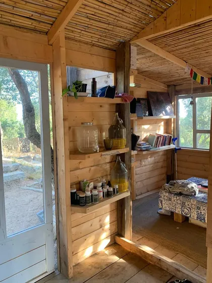 The simple, rustic interior of our accommodation in Sardinia. The natural wood and tranquil setting provide a peaceful space for rest and reflection after a day of yoga practice.