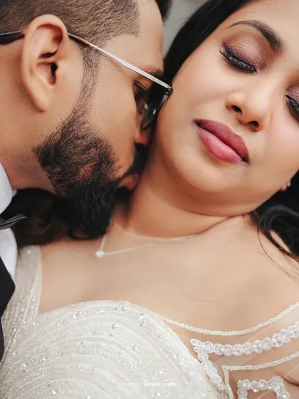 An intimate close-up of the groom whispering to his bride, a moment of shared secrets and affection.