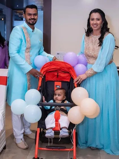 The proud parents with their little bundle of joy, Parv, in his stroller. A beautiful family moment captured during his heartwarming naming ceremony.