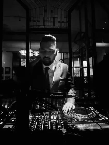 A moody, low-light shot of me in my suit and tie. I can create a sophisticated and cool atmosphere for any upscale party.