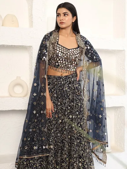 A full-length view of the navy blue mirror-work lehenga. The intricate craftsmanship and sparkling details make it a true showstopper.