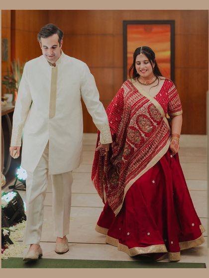 The couple walks hand-in-hand, sharing a happy moment together. This candid shot captures the ease and comfort of their 12-year love story.