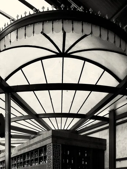 Looking up at the intricate structure of the bar's canopy lighting. The design is both functional as a light source and a major decorative feature.