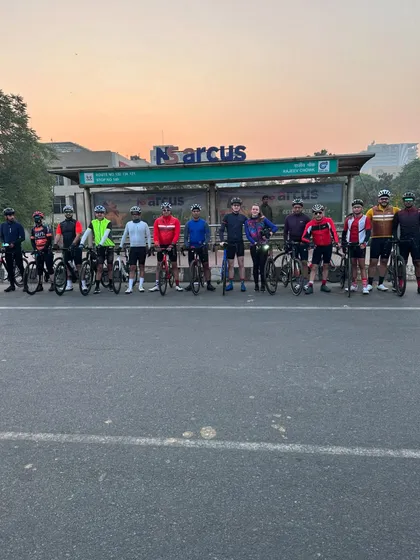The group posing at a bus stop mid-ride. Quick breaks are essential for regrouping and refueling on our long Sunday journeys.
