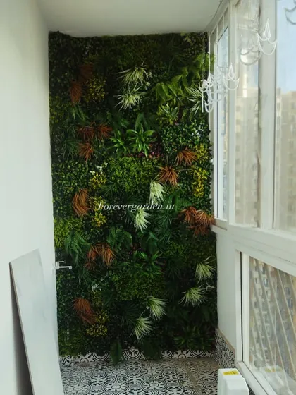 The final look of the autumn-toned vertical garden, showing how it adds warmth and texture to the small balcony.