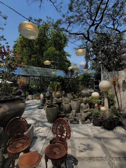 The curated courtyard at Beruru, filled with eclectic decor and lush plants. This project highlights our philosophy of creating spaces that are rich in detail and narrative.