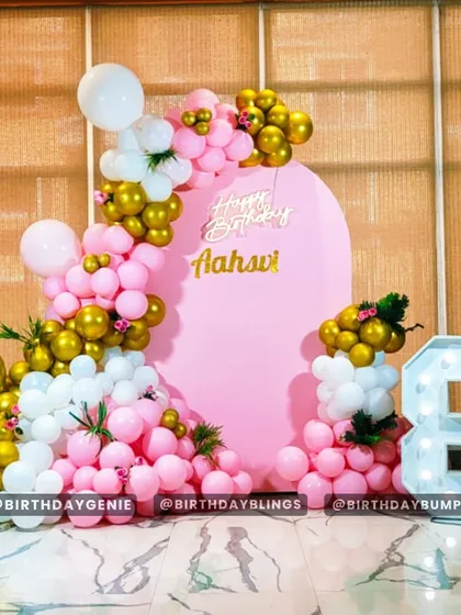 A glamorous 8th birthday party with a pink, white, and gold color scheme. The large light-up number '8' and personalized backdrop create a stunning focal point.